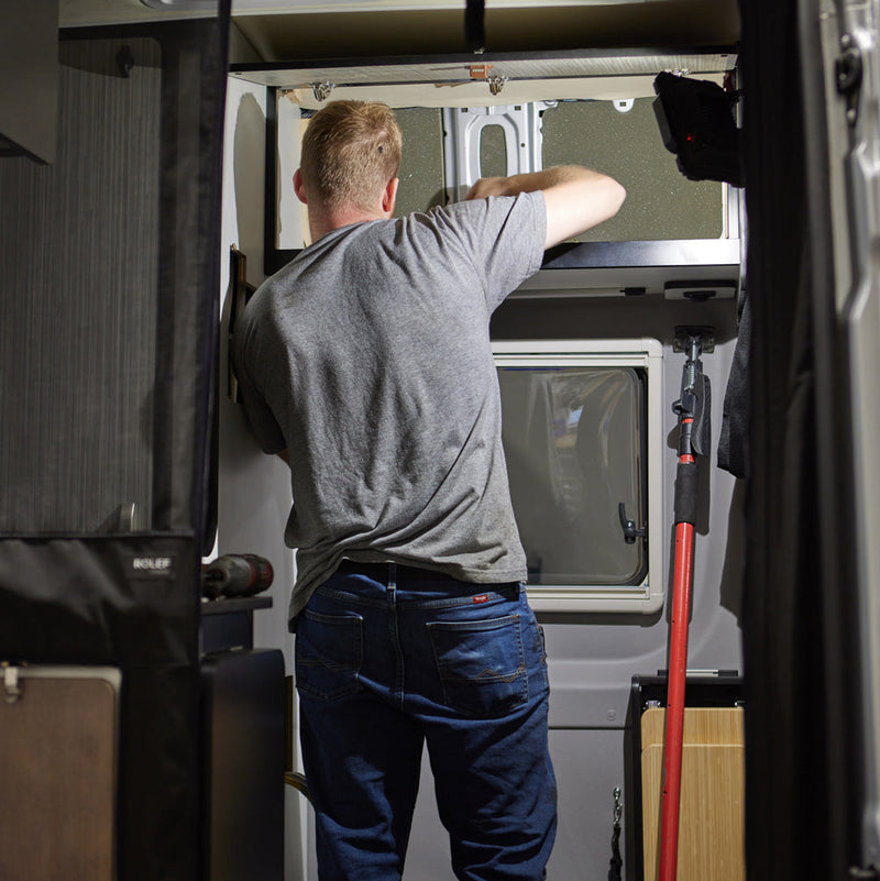 Person working on the interior of a campervan